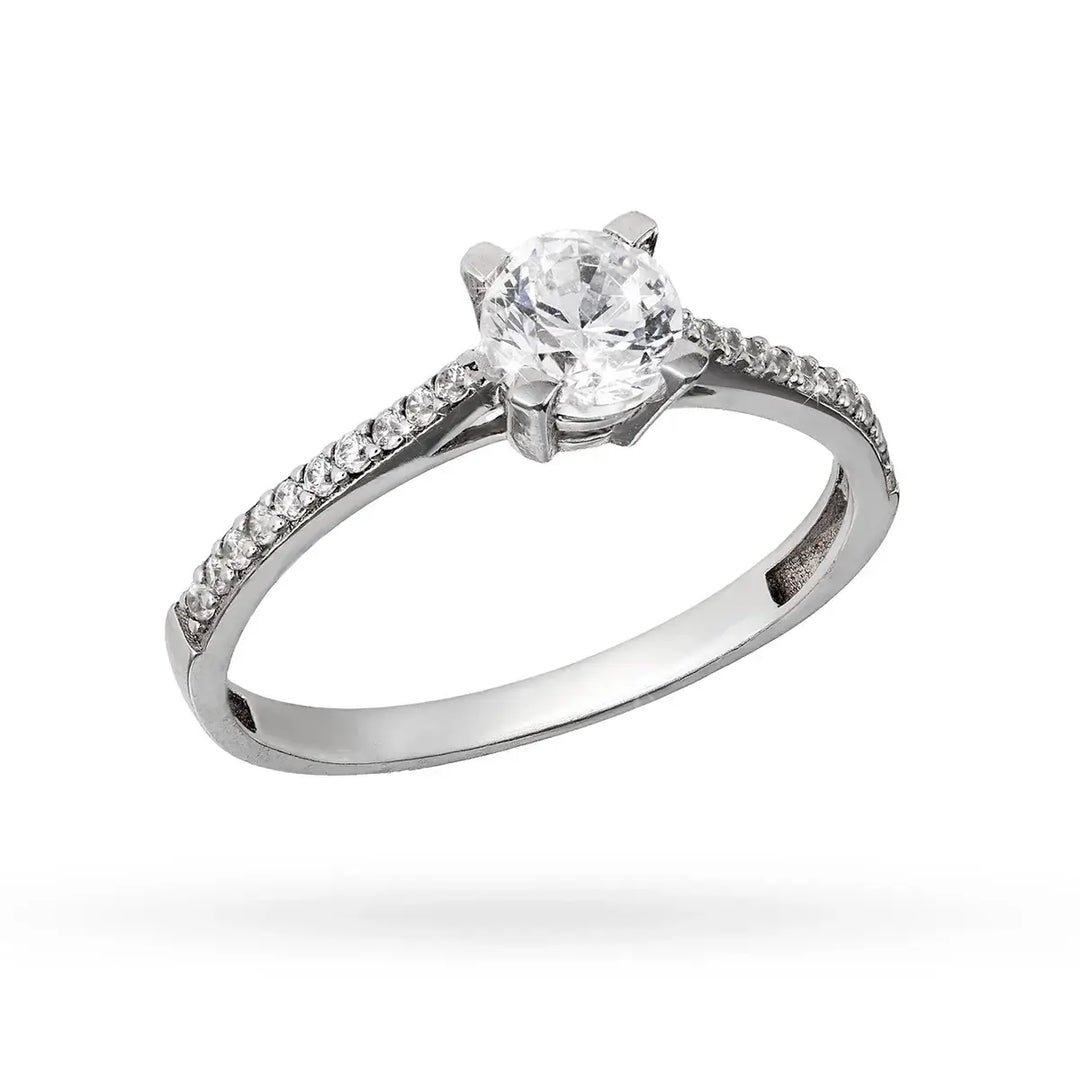 Бял златен пръстен с централен циркон и камъни по халката